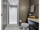 Bathroom featuring walk in shower, gray walls, tile floors, modern fixtures, and granite countertop vanity at 9476 Oakley Dr, Indianapolis, IN 46260