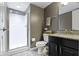 Modern bathroom with a shower, toilet, vanity, and gray walls at 9476 Oakley Dr, Indianapolis, IN 46260