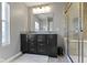 Bathroom with granite vanity, large mirror, and glass-enclosed shower at 9476 Oakley Dr, Indianapolis, IN 46260