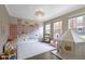 Charming bedroom with a city mural, bright windows, unique light fixture, and playful decor at 9476 Oakley Dr, Indianapolis, IN 46260