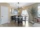 Bright dining room featuring contemporary light fixture, modern art, and sliding glass door to balcony at 9476 Oakley Dr, Indianapolis, IN 46260