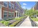 Row of brick townhomes with well-maintained landscaping and walkway at 9476 Oakley Dr, Indianapolis, IN 46260