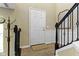 Inviting foyer with hardwood floors, coat rack, and staircase at 9476 Oakley Dr, Indianapolis, IN 46260
