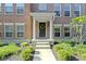 Charming brick home featuring a welcoming front door with decorative wreath and covered porch at 9476 Oakley Dr, Indianapolis, IN 46260