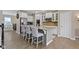 Bright kitchen featuring an island with bar stool seating, stainless appliances, and white cabinets at 9476 Oakley Dr, Indianapolis, IN 46260