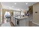 Open concept kitchen featuring a large island, granite countertops, stainless steel appliances, hardwood floors, and seating at 9476 Oakley Dr, Indianapolis, IN 46260