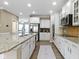 Bright kitchen featuring stainless appliances, white cabinets, an island, and hardwood floors at 9476 Oakley Dr, Indianapolis, IN 46260