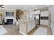 Open kitchen floor plan featuring white cabinets, stainless steel appliances, hardwood floors, and granite countertops at 9476 Oakley Dr, Indianapolis, IN 46260