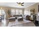 Living room featuring plush sectional sofa, fireplace, large windows, and sliding glass door to balcony at 9476 Oakley Dr, Indianapolis, IN 46260