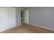 This bedroom has neutral paint, tan carpeting, and double sliding door closet for ample storage at 951 W Mckay Rd, Shelbyville, IN 46176