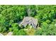 Aerial view of a two-story home nestled among mature trees and green grass at 9690 Irishmans Run Ln, Zionsville, IN 46077