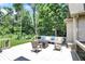 This spacious back deck features comfortable outdoor seating, a modern fire table, and views of the lush, private backyard at 9690 Irishmans Run Ln, Zionsville, IN 46077