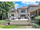 A spacious deck with outdoor seating and grill, overlooking a beautifully landscaped backyard perfect for entertaining guests at 9690 Irishmans Run Ln, Zionsville, IN 46077