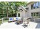 This spacious back deck features comfortable outdoor seating, a modern fire table, and views of the lush, private backyard at 9690 Irishmans Run Ln, Zionsville, IN 46077