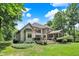 The rear exterior reveals a spacious deck, screened-in porch, and verdant lawn, blending indoor and outdoor living at 9690 Irishmans Run Ln, Zionsville, IN 46077