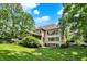 A spacious back exterior features a screened porch and numerous windows, creating a light-filled and inviting atmosphere at 9690 Irishmans Run Ln, Zionsville, IN 46077