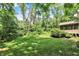 Lush backyard with mature trees and verdant lawn, providing a serene and private outdoor retreat at 9690 Irishmans Run Ln, Zionsville, IN 46077