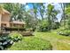 Expansive backyard featuring a deck, lush greenery, and mature trees, ideal for outdoor living and entertaining at 9690 Irishmans Run Ln, Zionsville, IN 46077