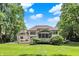 A rear view shows a spacious deck, screened porch, and sprawling lawn, perfect for relaxation and recreation at 9690 Irishmans Run Ln, Zionsville, IN 46077