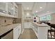 Close up of a wet bar in a finished basement with tile floors and white cabinets at 9690 Irishmans Run Ln, Zionsville, IN 46077