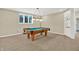 Finished basement area featuring a pool table, a window, and built in shelving at 9690 Irishmans Run Ln, Zionsville, IN 46077