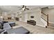 Spacious finished basement with neutral carpet, a comfortable seating area, a wet bar, and a stairway at 9690 Irishmans Run Ln, Zionsville, IN 46077
