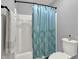 This bathroom features a shower with a stylish blue curtain and a modern toilet at 9690 Irishmans Run Ln, Zionsville, IN 46077