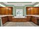 Luxurious bathroom featuring a soaking tub with wood cabinetry and double sinks at 9690 Irishmans Run Ln, Zionsville, IN 46077