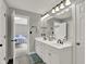 Bright bathroom features a double sink vanity with framed mirror and modern lighting at 9690 Irishmans Run Ln, Zionsville, IN 46077