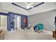 Large bedroom with blue accent wall, seating, and desk at 9690 Irishmans Run Ln, Zionsville, IN 46077