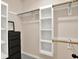 Spacious walk-in closet with custom shelving, rod storage, and dresser at 9690 Irishmans Run Ln, Zionsville, IN 46077