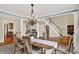 Bright dining room features natural light, elegant chandelier, and is open to the staircase at 9690 Irishmans Run Ln, Zionsville, IN 46077