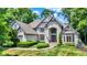 Beautiful two-story home with manicured lawn and mature trees and bushes at 9690 Irishmans Run Ln, Zionsville, IN 46077