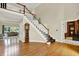 Spacious foyer with hardwood floors, staircase, and views into living areas, creating an inviting and open feel at 9690 Irishmans Run Ln, Zionsville, IN 46077