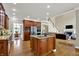 Open kitchen with a central island, stainless appliances, and hardwood floors at 9690 Irishmans Run Ln, Zionsville, IN 46077