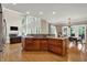 Open kitchen featuring a center island with granite countertops, hardwood floors, and open layout at 9690 Irishmans Run Ln, Zionsville, IN 46077