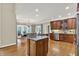 Stylish kitchen featuring a center island, hardwood floors, and stainless steel appliances at 9690 Irishmans Run Ln, Zionsville, IN 46077