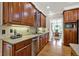 Well-lit kitchen with stainless steel appliances, granite countertops, and custom wood cabinets at 9690 Irishmans Run Ln, Zionsville, IN 46077