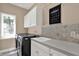 Well-equipped laundry room with modern appliances and plenty of cabinet space at 9690 Irishmans Run Ln, Zionsville, IN 46077