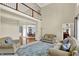Open-concept living room with soaring ceilings, balcony overlook, and views into the formal dining room at 9690 Irishmans Run Ln, Zionsville, IN 46077