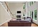 Bright living room boasts a cozy fireplace, hardwood floors, and lots of natural light at 9690 Irishmans Run Ln, Zionsville, IN 46077