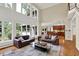 Open-concept living room features hardwood floors, lots of windows, and views into the kitchen at 9690 Irishmans Run Ln, Zionsville, IN 46077