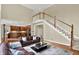 Open-concept living room features hardwood floors, lots of windows, and views into the kitchen at 9690 Irishmans Run Ln, Zionsville, IN 46077