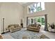 Bright living room featuring large windows, neutral tones, plush seating, and stylish floral area rug at 9690 Irishmans Run Ln, Zionsville, IN 46077