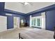 This primary bedroom boasts a tray ceiling, large windows and neutral carpet flooring at 9690 Irishmans Run Ln, Zionsville, IN 46077