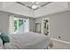Bright main bedroom with tray ceiling, large window and en suite bathroom at 9690 Irishmans Run Ln, Zionsville, IN 46077