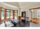 Bright home office boasting natural light, a dark wood desk, and serene outdoor views at 9690 Irishmans Run Ln, Zionsville, IN 46077
