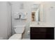 Bathroom featuring toilet and a dark vanity topped with white countertop and single sink at 9806 Olympic Blvd, Pendleton, IN 46064