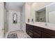 Bright bathroom featuring double sinks, a large mirror, and a glass-enclosed shower at 9806 Olympic Blvd, Pendleton, IN 46064