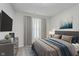 Serene bedroom with gray and blue accents, complemented by natural light and modern decor at 9806 Olympic Blvd, Pendleton, IN 46064
